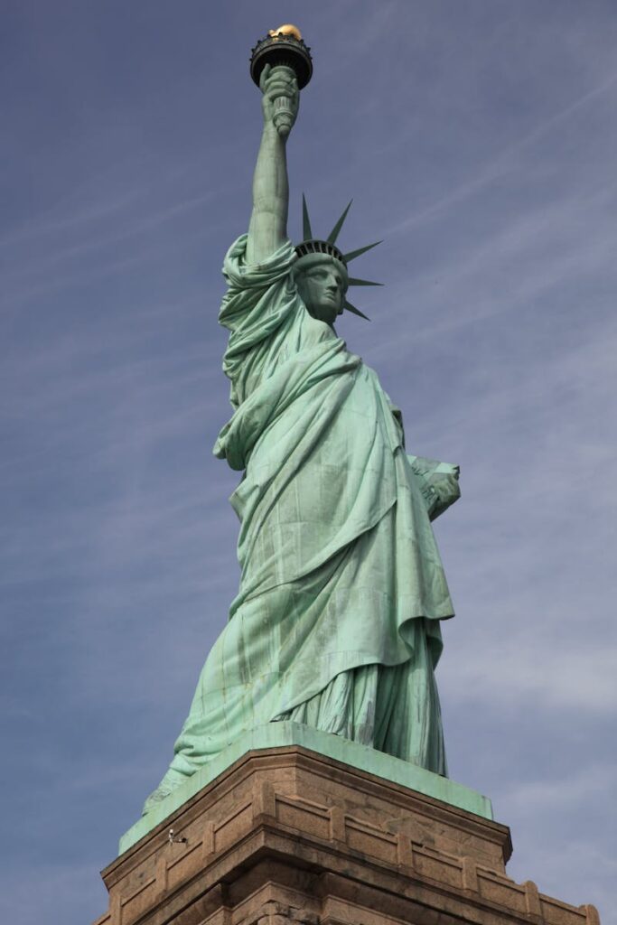 Iconic Statue of Liberty against a clear blue sky in New York City.